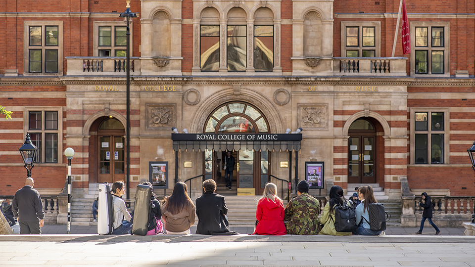 Students sat on steps, facing the front of the RCM's Blomfield building